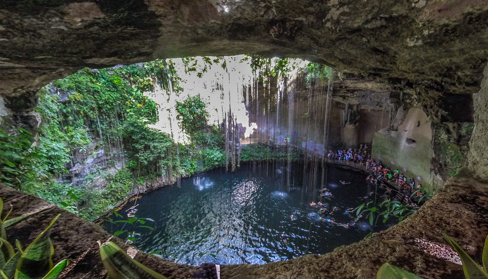 Ik-kil cenote ion the Yucatan Peninsula is a vine-covered sink hole popular for cliff diving. 