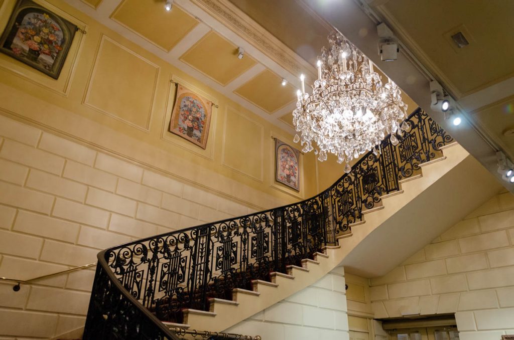 Inside the Cheers Bar Boston is a grand staircase, leading up to what is now a wedding venue. 