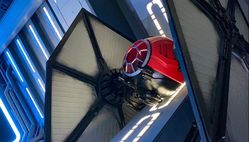 Star Wars Rise of the Resistance tie fighter dominates the scene in the hangar